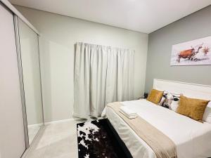 a bedroom with a bed and a window at Shamah in Pretoria