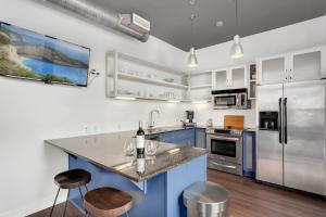 a kitchen with blue cabinets and stainless steel appliances at The East View - Downtown - Steps to Dickson in Fayetteville