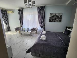 a bedroom with a large bed and a living room at Київські Ночі in Kyiv