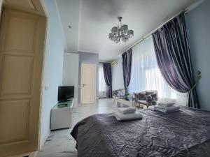 ein Schlafzimmer mit einem Bett und ein Wohnzimmer in der Unterkunft Київські Ночі in Kiew