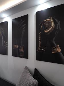 a room with three paintings on a wall at Black&White mountain - ADULTS ONLY in Petroşani