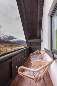 a balcony with chairs and a view of the ocean at Apartments Kot'č in Kranjska Gora