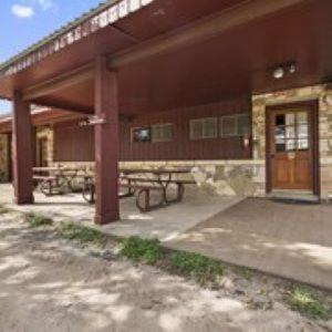a building with a picnic table in front of it at Thunderbird Lodge in Burnet