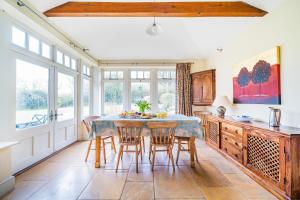 a kitchen with a table and chairs in a room at Manor Farm House in Kilmington