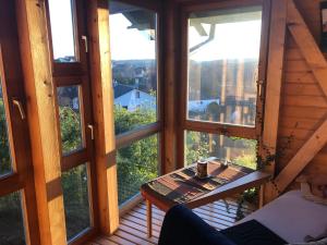 a room with a table on a balcony with windows at Außergewöhnliches Ferienhaus im Schwarzwald in Dornstetten
