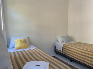 Postel nebo postele na pokoji v ubytování Vila Rita Hostel Arraial d'Ajuda