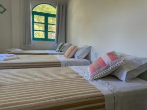 Postel nebo postele na pokoji v ubytování Vila Rita Hostel Arraial d'Ajuda