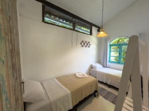 Postel nebo postele na pokoji v ubytování Vila Rita Hostel Arraial d'Ajuda