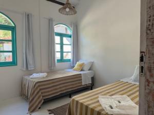 Postel nebo postele na pokoji v ubytování Vila Rita Hostel Arraial d'Ajuda