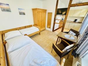 a bedroom with a bed and a desk and a ladder at Appartement Feuerdorn in Warnemünde