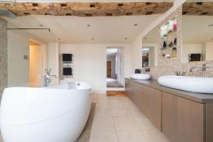 a large bathroom with a tub and a sink at Bank Farm House - Stunning House & Gardens in Shenstone