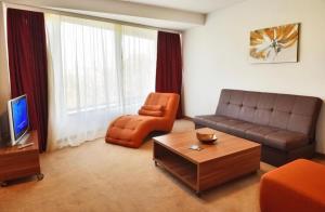 a living room with a couch and a chair at Hotel Pension Matteo in Augsburg