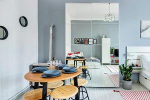 a kitchen and dining room with a table and chairs at S3 Sörház Apartment in Budapest