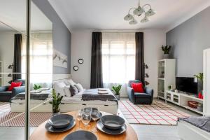 a living room with a couch and a table at S3 Sörház Apartment in Budapest