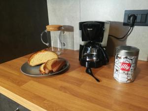 a table with a plate of bread and a coffee maker at B&B Ferluga in Trieste