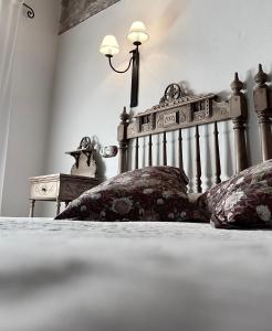 a black and white photo of a bed with two pillows at Caserón De La Fuente in Albarracín