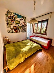 a bedroom with two beds and a painting on the wall at -Secret View - Marina di Carrara in Carrara