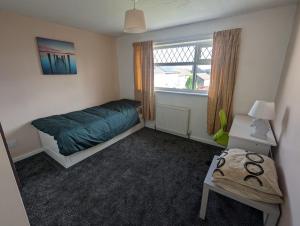 a small bedroom with a bed and a window at Rooms close to City Centre in Beeston Hill