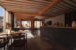 a kitchen and dining room with a table and chairs at Humble abode of happiness - Mountain View Wabi-sabi Lodge in Lijiang