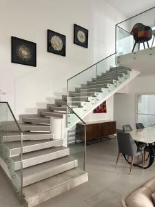a staircase in a room with a table and chairs at DUPLEX VIRAGE in Dakar