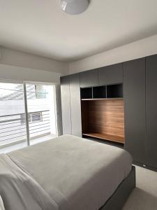 a bedroom with a bed and a large window at DUPLEX VIRAGE in Dakar