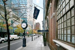 Club Quarters Hotel Rittenhouse Square, Philadelphia في فيلادلفيا: ساعة على عمود في شارع المدينة