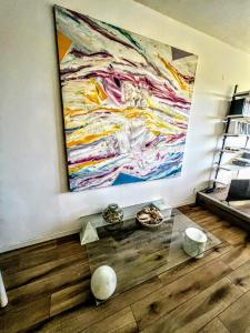 a painting hanging on a wall in a room at -Secret View - Marina di Carrara in Carrara