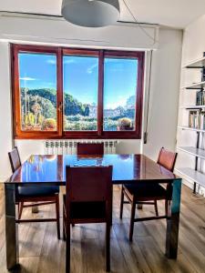 a dining room with a table and chairs and a window at -Secret View - Marina di Carrara in Carrara