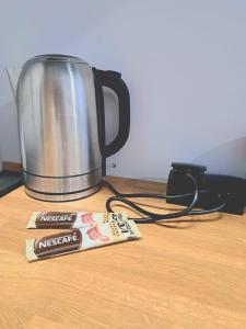 a packet of marshmallows next to a pot of coffee at Apartament Nova in Racibórz +7 photos
