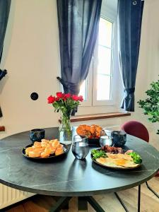 une table avec deux assiettes de nourriture dans l'établissement Apartament Nova, à Racibórz