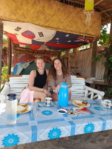 two women sitting at a table with food at 8 Star Paradise in Locaroc