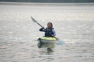 a young girl in a kayak in the water at Treehouse Chalets in Belihul Oya