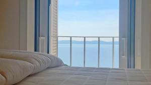 a bedroom with a bed and an open window at Grand Hotel - Appartement in Sainte-Maxime