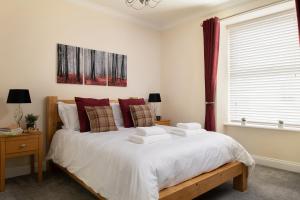 a bedroom with a bed with two towels on it at Nythfa in Llanrwst