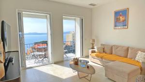 a living room with a couch and a view of the ocean at Grand Hotel - Appartement in Sainte-Maxime