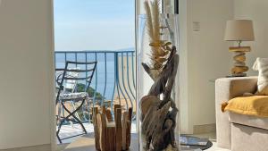 a living room with a view of the ocean at Grand Hotel - Appartement in Sainte-Maxime +10 photos