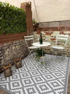 a table and two chairs on a checkered floor at Chapel Court - Worcester City Centre - Free Parking Available - Entire Apartment - Self Check-In - Outside Space - Free WI-FI in Worcester