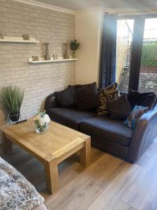 a living room with a couch and a coffee table at Chapel Court - Worcester City Centre - Free Parking Available - Entire Apartment - Self Check-In - Outside Space - Free WI-FI in Worcester