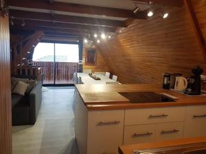 a kitchen and living room with a couch and a table at Chalet Le Casalandre in Arette