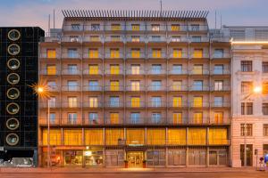 a large building with many windows on a city street at Select Hotel Prinz Eugen Wien in Vienna