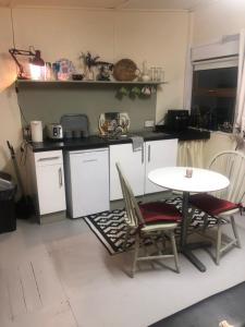 a kitchen with a table and two chairs and a table at Bob’s Cabin in Galway