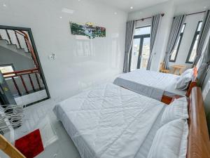 Postel nebo postele na pokoji v ubytování Homestay Tiến Đạt