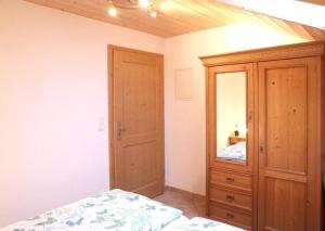 a bedroom with a bed and a wooden cabinet at Appartement in Farchant in Farchant