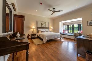 a bedroom with a bed and a piano at Chimneys Nuwara Eliya in Nuwara Eliya