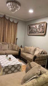 a living room with a couch and a table at فيلا العزيزيه - الخبر in Al ‘Azīzīyah