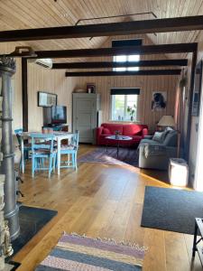 a living room with a couch and a table at Bo i egen stuga på härlig ölandsgård in Köpingsvik