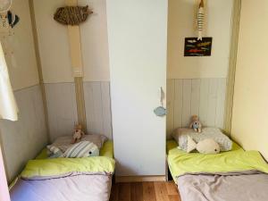 a room with two beds with teddy bears on them at Casa di Babbo …la Cabane in Sorbo-Ocagnano