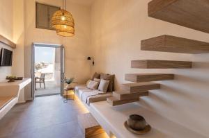 a living room with a staircase and a couch at Frescoes Luxury Suites in Mesaria