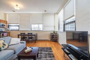 a living room with a couch and a table at Spacious Downtown Loft #1 with AC in Halifax