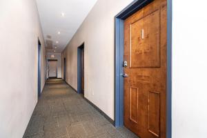 an empty corridor with a wooden door and a hallway at Spacious Downtown Loft #1 with AC in Halifax